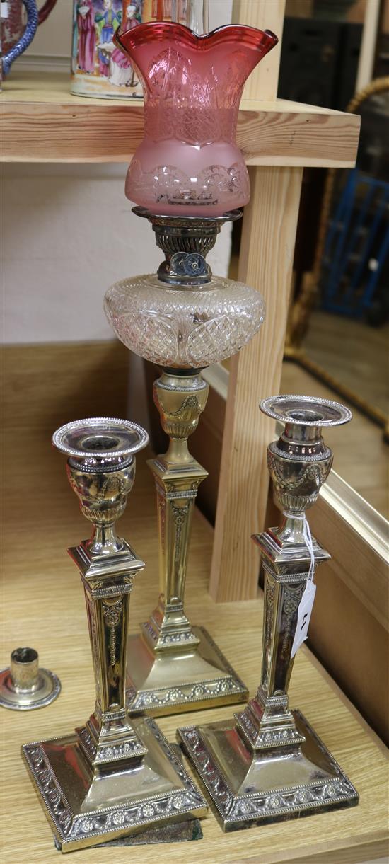 A Victorian oil lamp and a pair of plated candlesticks